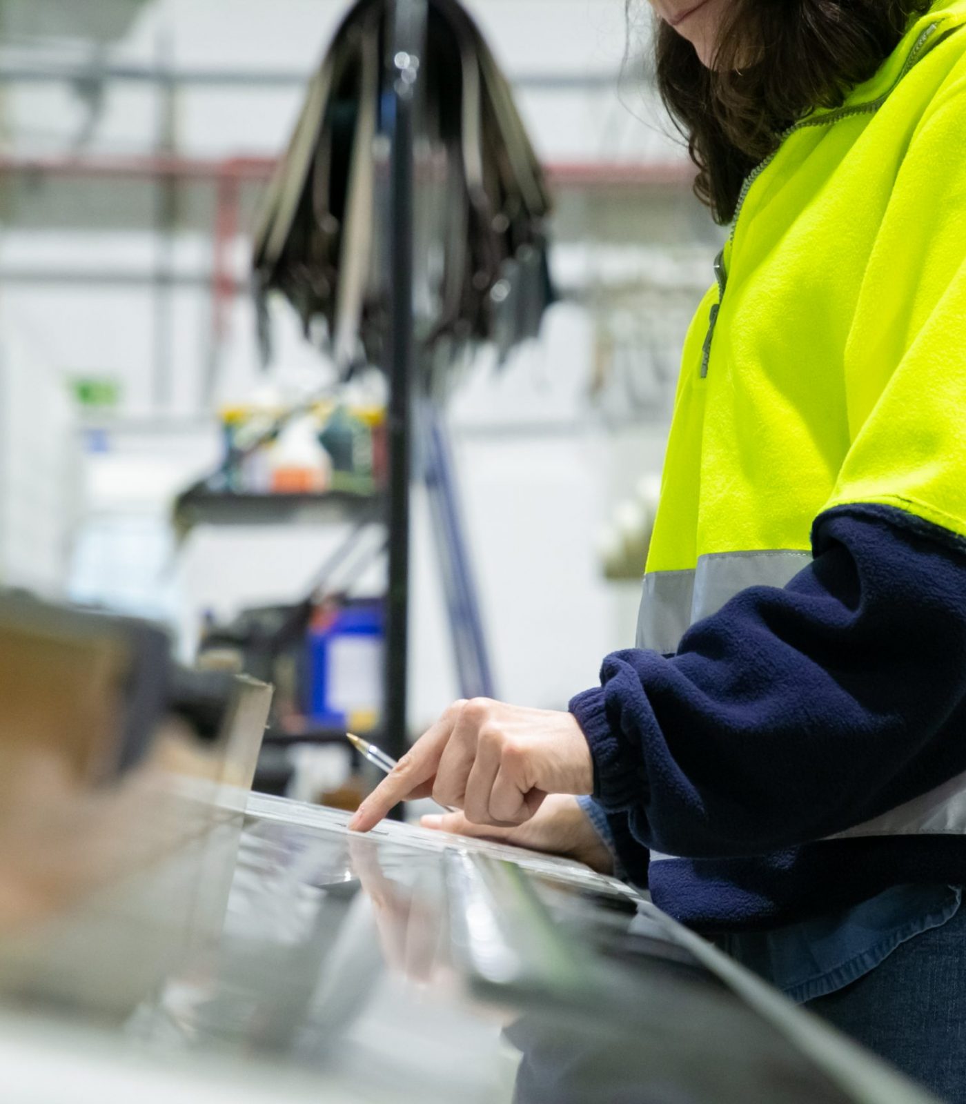 Industrial engineer programming machine at control panel. Cropped shot of woman in uniform working at plant. Manufacturing concept